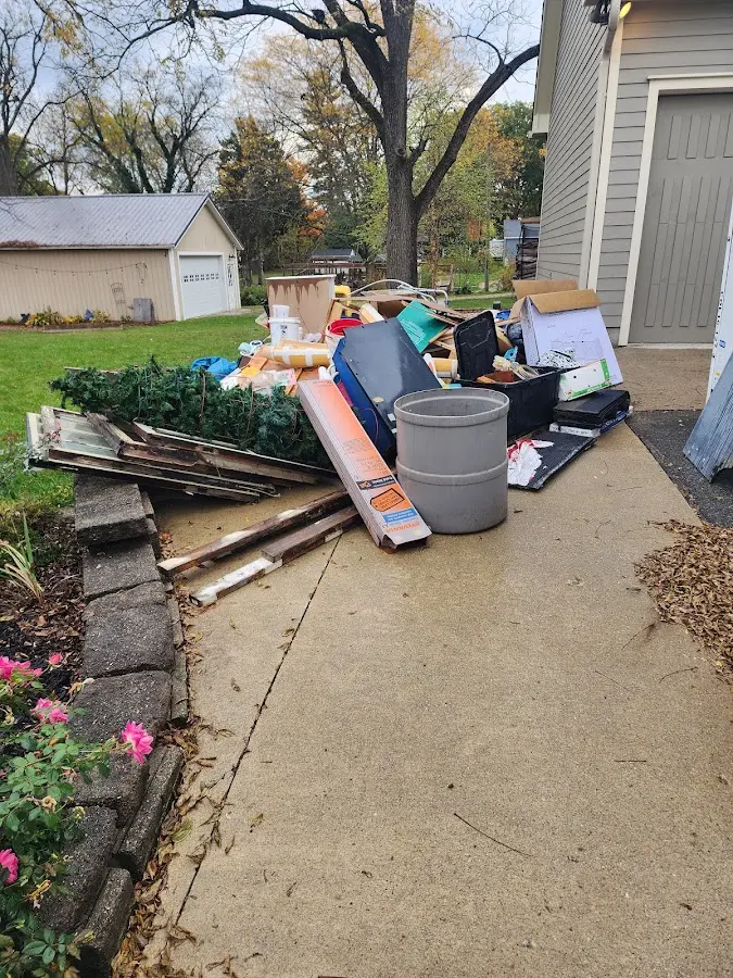 Dumpster being loaded with debris for 3 Yard Dumpster Rental in Tehaleh
